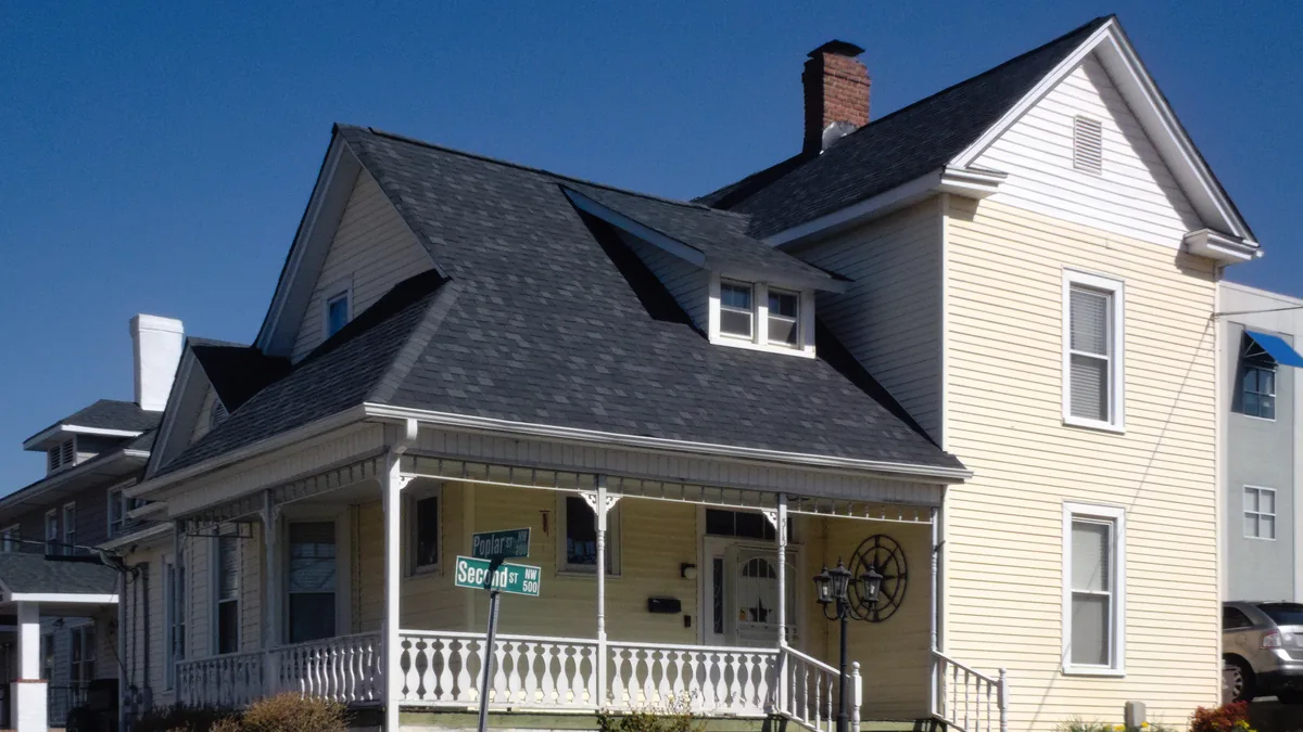 A two-storey cream-coloured house with a covered front porch on a corner lot in Winston-Salem, North Carolina