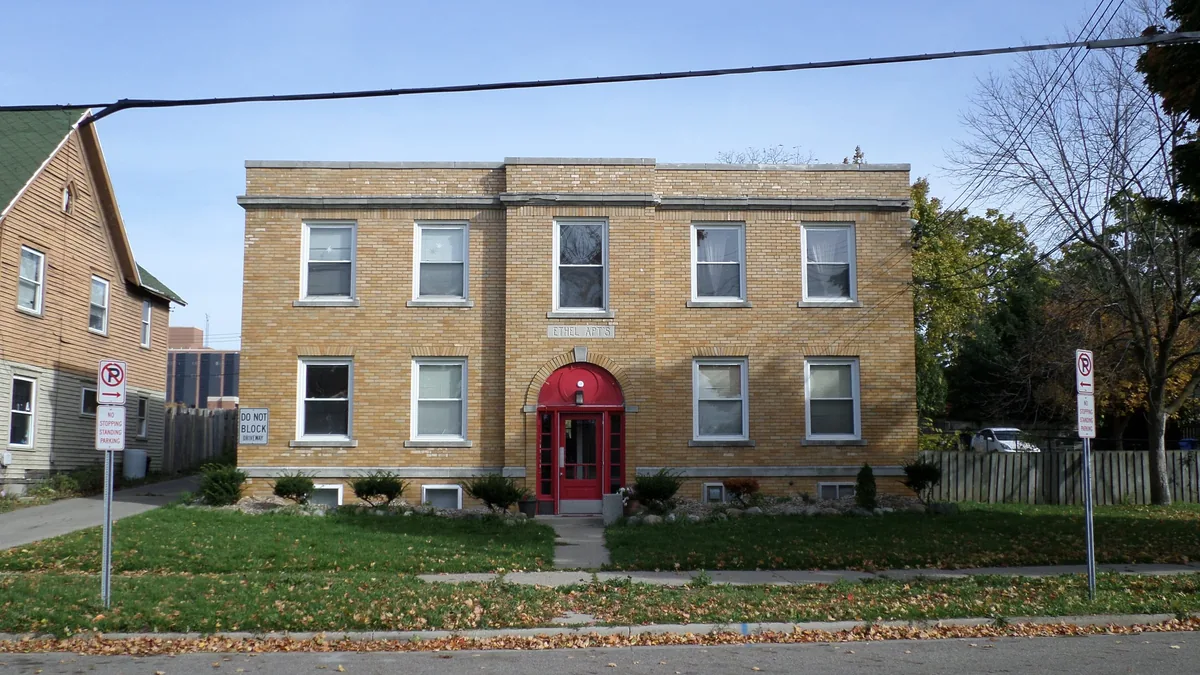 A small brick apartment building of the kind sold with tenants in place